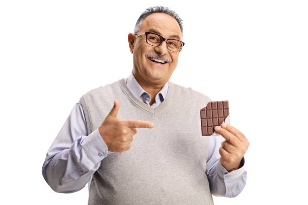 istock Happy mature man holding a chocolate and pointing 1320388655