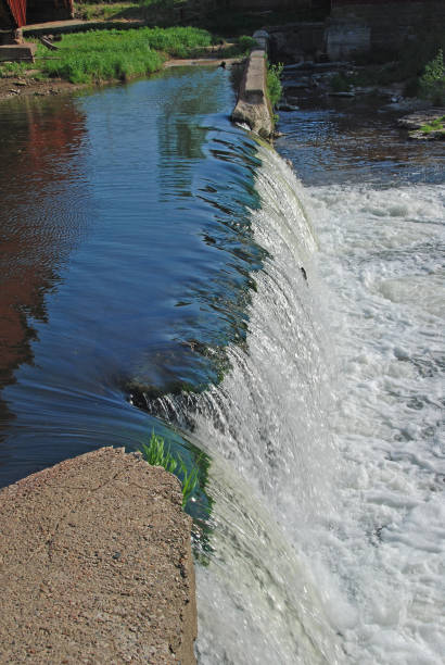 istock Water Flowing Over a Rural Dam 1320389464