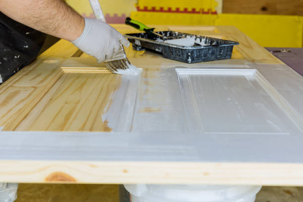 istock Contractor master processes painting for painting wooden doors with using paintbrush 1320389490