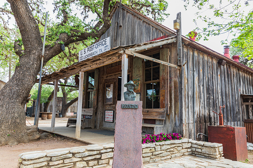 Luckenbach, Texas, USA. April 13, 2021. Statue of Hondo Crouch outside the post office in Luckenbach, Texas.