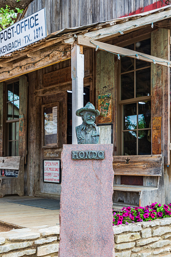 Luckenbach, Texas, USA. April 13, 2021. Statue of Hondo Crouch outside the post office in Luckenbach, Texas.