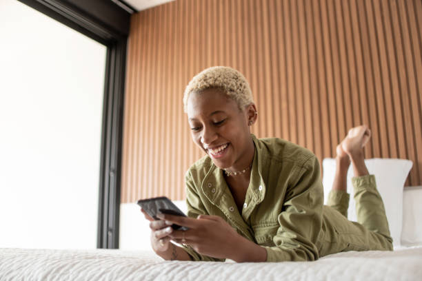 istock Teen girl using cellphone in bed. 1320390531