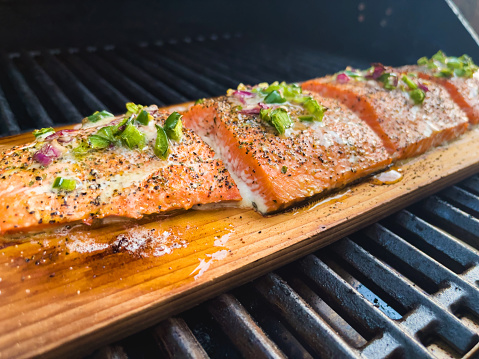 Western USA Summer BBQ Grilled Salmon Files on Cedar Plank 4K Matching Video Available(Shot with iPhone 12 Pro Max 12mp 4032 × 3024 photos professionally retouched - Lightroom / Photoshop -downsampled as needed for clarity and select focus used for dramatic effect)