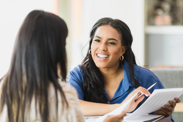 istock Smiling confident female financial advisor works with client 1320392479