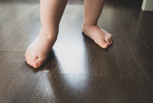 istock Children's feet take their first steps. The first steps of a child. 1320392936