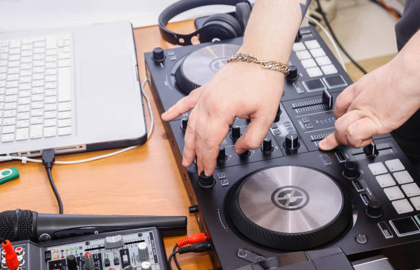 istock dj remote with his hands on it close up 1320393046