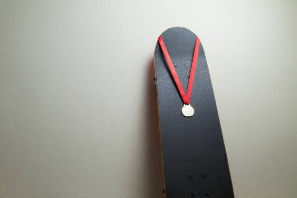 istock Skateboard on the wall with a gold medal. 1320393628
