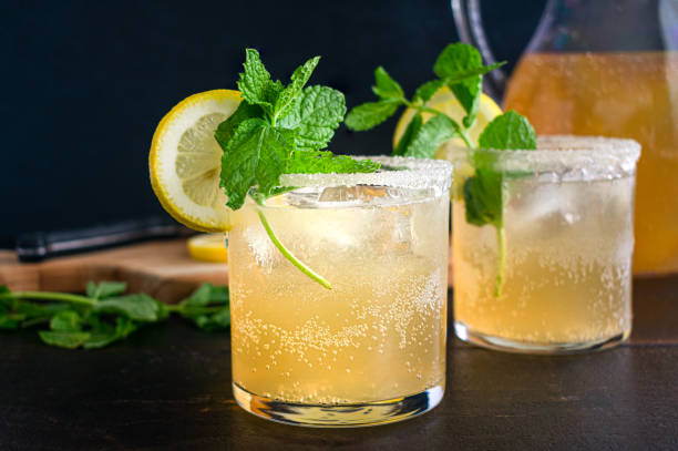 Kentucky Lemonade Cocktails Bourbon and lemonade cocktail served in sugar-rimmed glasses with garnish glass of bourbon stock pictures, royalty-free photos & images