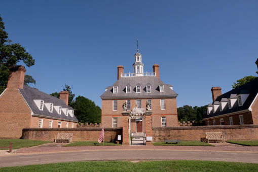 The Governor's Palace in Colonial Williamsburg, Virginia. A brick Colonial house with a courtyard, and former home of Thomas Jefferson.