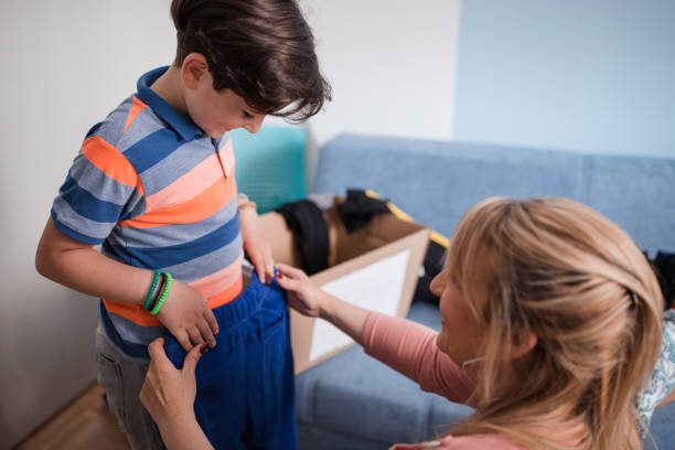 istock Boy holding pants his mom is giving him 1320396251