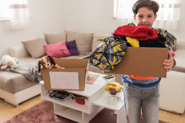istock Kid carrying box of clothes 1320396301