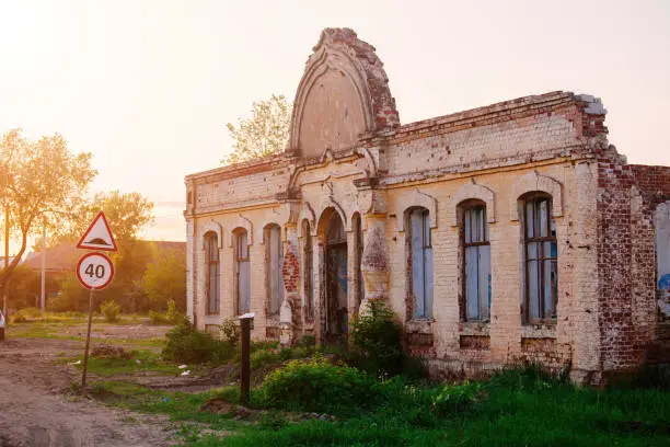 Old ruined historical house at the evening sunset.