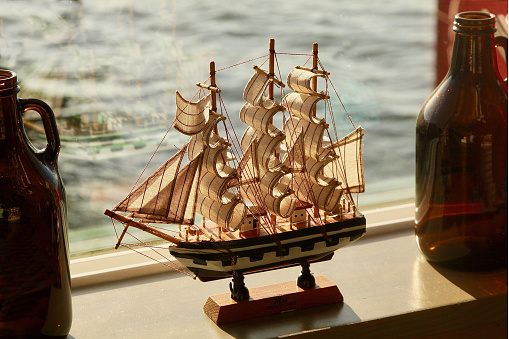 Small model of a three masted ship sitting in a window in the lobby of a restaurant