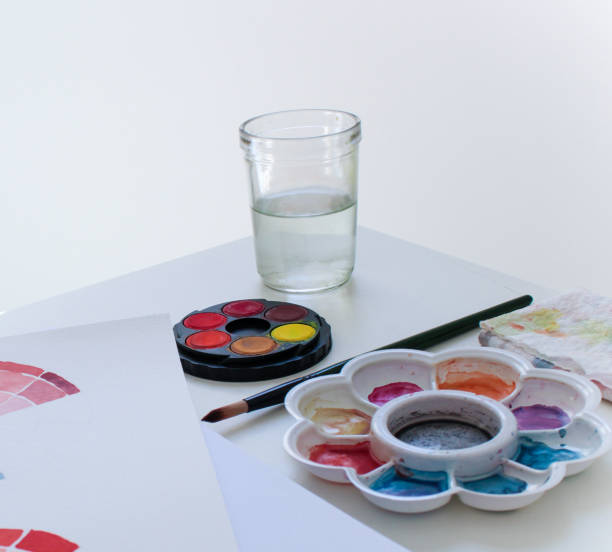 istock Material for watercolor painting, white paper, empty background, color test brushes 1320403915