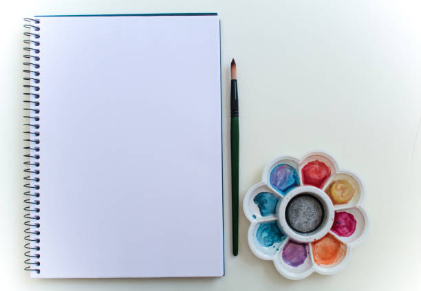 istock Material for watercolor painting, white paper, empty background, color test brushes 1320403959