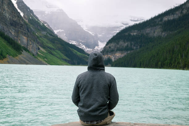 istock View of mans back admiring Lake Louise 1320406809