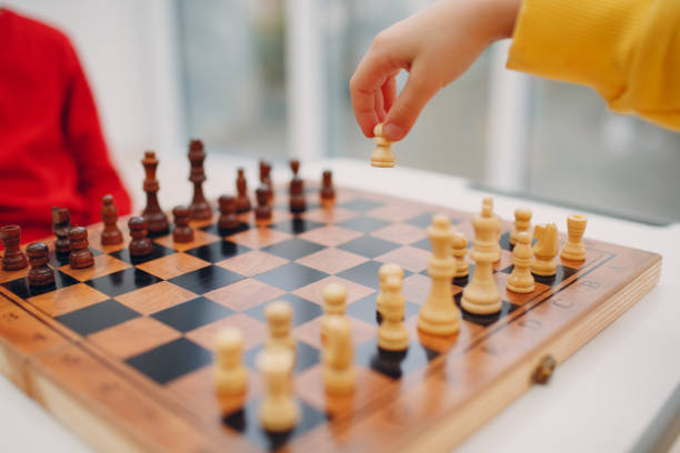 istock Little kids playing chess at kindergarten or elementary school 1320406949