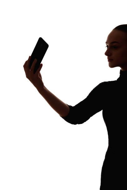 istock woman silhouette mobile video call phone selfie 1320406966