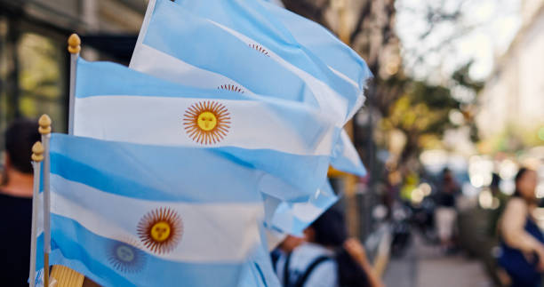 Multiple Argentinian flags flapping.