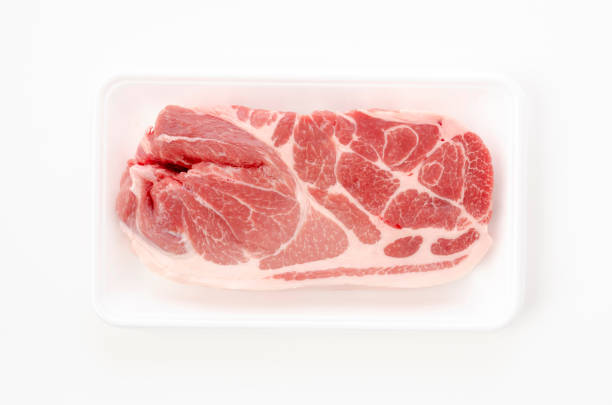 istock Raw pork meat in foam tray on white background 1320413836