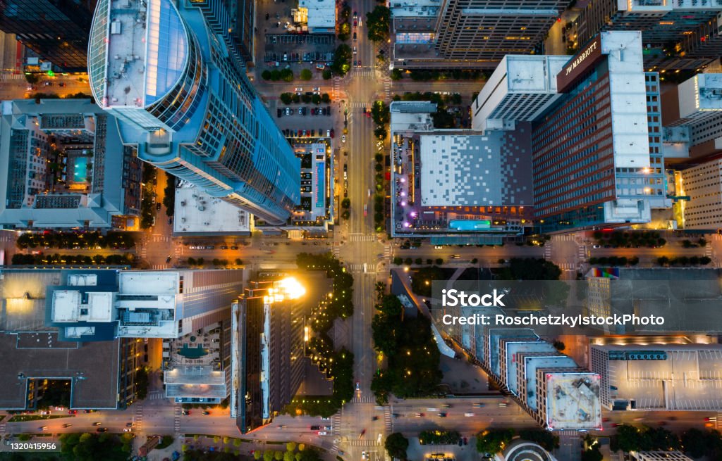 Straight down Above Tall Towers rising over Austin Texas Straight down Above Tall Towers rising over Austin Texas at Blue Hour sunset with Urban City lights illuminated the City Streets and intersections City Stock Photo