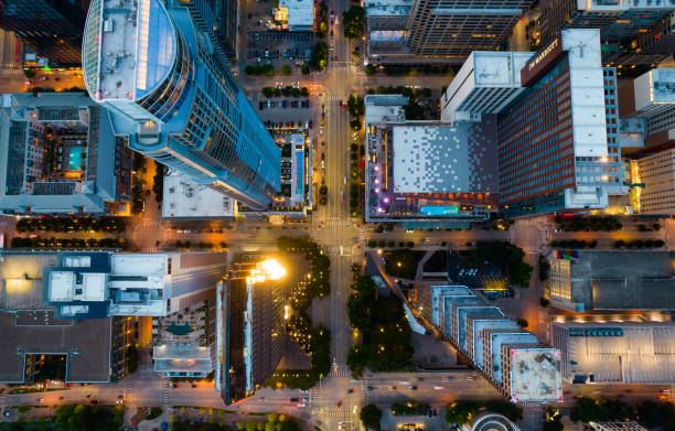 Straight down Above Tall Towers rising over Austin Texas Straight down Above Tall Towers rising over Austin Texas at Blue Hour sunset with Urban City lights illuminated the City Streets and intersections aerial view stock pictures, royalty-free photos & images