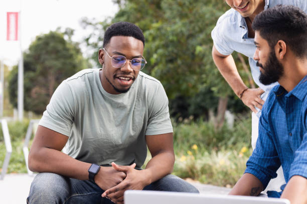 istock African-Australian Student Relaxing With Friends On Campus 1320421719