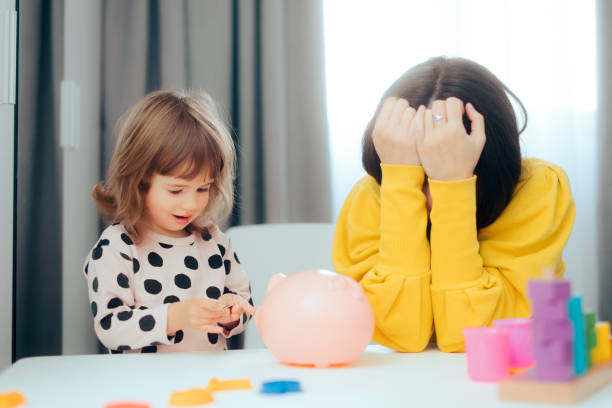 Stressed Mom Teaching her Child about Money and Savings Single parent teaching financial responsibility feeling concerned and insecure about the economy for future generations family mother poverty sadness stock pictures, royalty-free photos & images