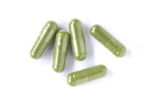 istock green herbal medicine capsules pills isolated on white 1320432216