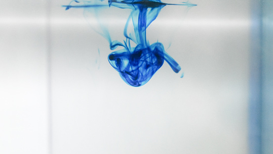 Drop of chemical Methylene Blue disolve in water
