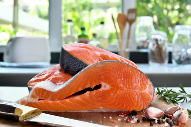 istock Fresh raw salmon fillet steaks with ingredient on a cutting board in the kitchen 1320434233