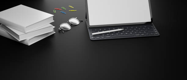 istock Digital tablet with mock-up screen, accessories, glasses and books on black table, 3D rendering 1320435853
