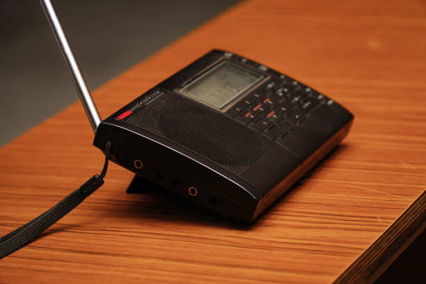 istock Black analog radio receiver on wooden table 1320438743