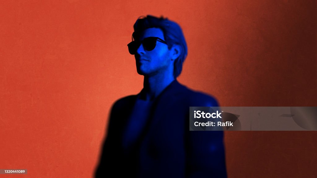 Shades 3D illustration of a man wearing shades and a black suit on a red background. Pop Musician Stock Photo