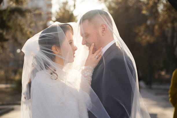 gentle and romantic bride and groom under the veil.