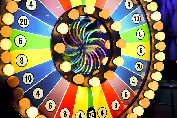 istock Spinning wheel of fortune with light bulbs and colors  132044489