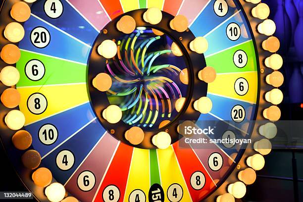 Spinning Wheel Of Fortune With Light Bulbs And Colors Stock Photo - Download Image Now