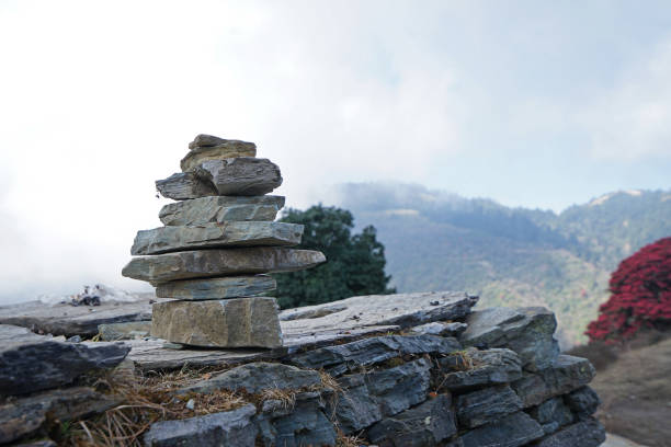 istock Prayer stone stacks with cloudy blue sky and green mountain view 1320445760