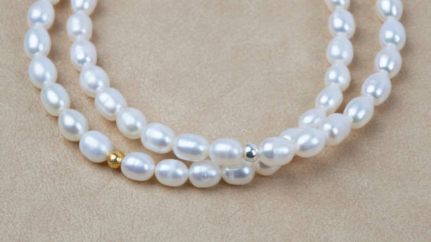 istock Luxury elegant baroque pearl bracelets on beige textured leather background 1320446885