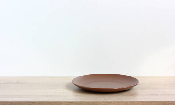 istock empty plate on a wooden table or shelf. kitchen background. 1320447689