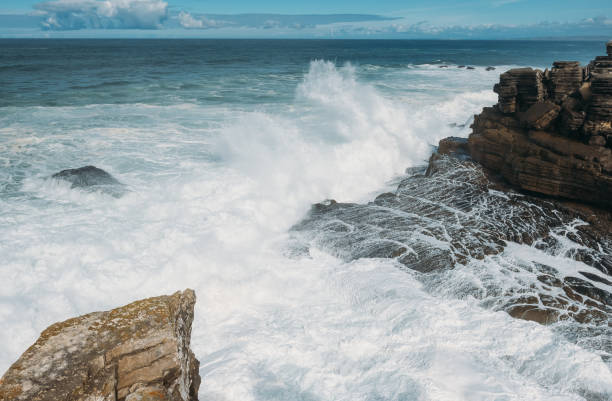 istock Ocean waves crashing against the stone shore 1320447704