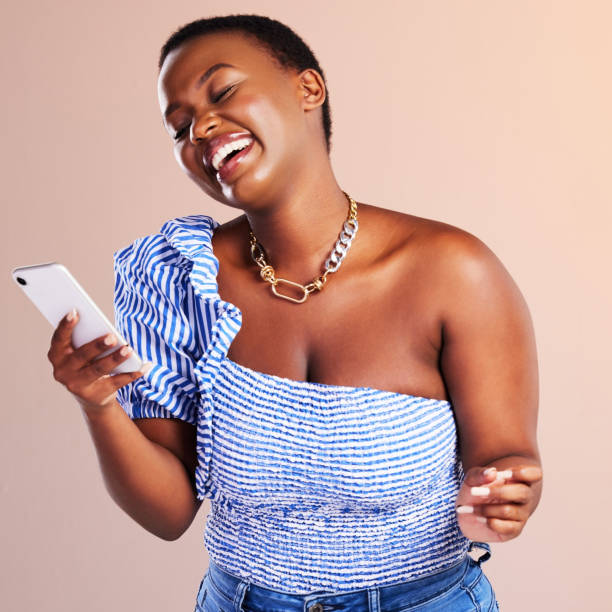 istock Studio shot of a young woman using a smartphone against a pink background 1320449158