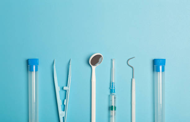 medical instruments, devices and items on the colored table in the hospital. syringe, test tube, tweezers. healthcare, medicine, treatment and doctors concept - nurse hygiene emotional stress surgeon imagens e fotografias de stock