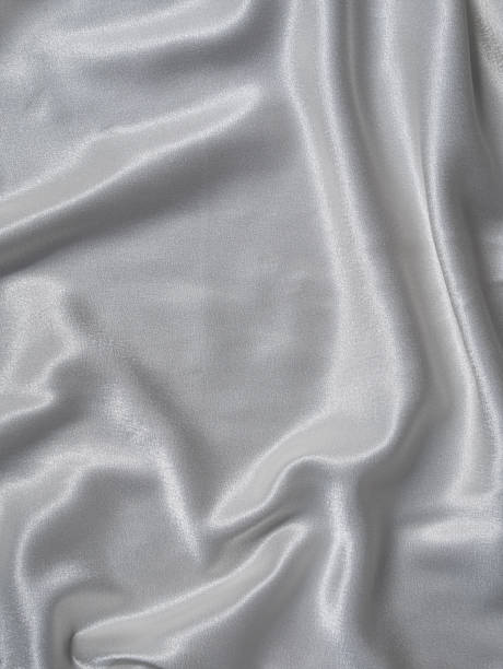 istock White satin background with folds and shadows. Light shiny rippled silk texture website advertisement design. 1320452242