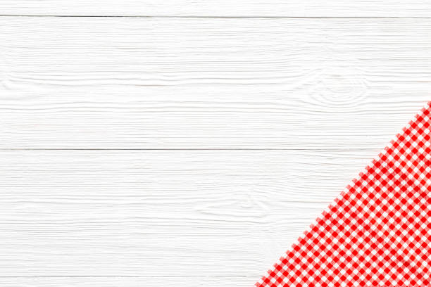 istock Red picnic cloth on wooden table, top view 1320458008