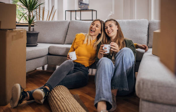 istock Lesbian couple relaxing in new home 1320458583