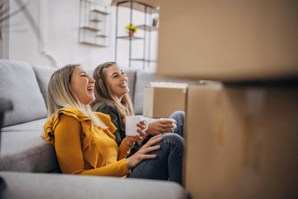istock Lesbian couple relaxing in new apartment 1320458805