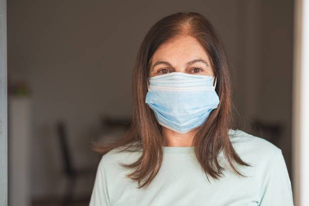 istock Senior woman getting ready to go out with triple mask! 1320460024