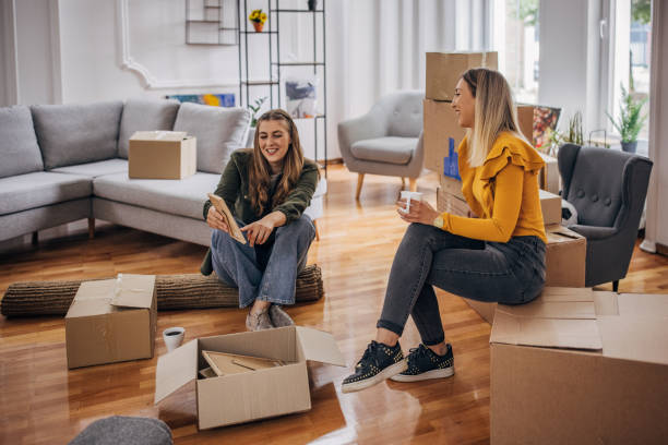 istock Lesbian couple unpacking in new home 1320460027