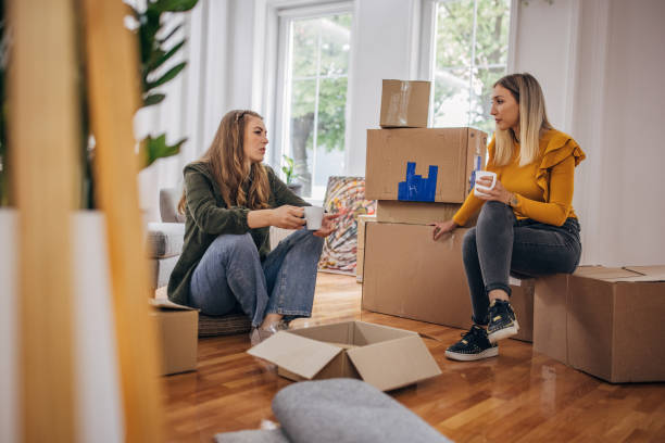 istock Lesbian couple sitting in new home 1320460088